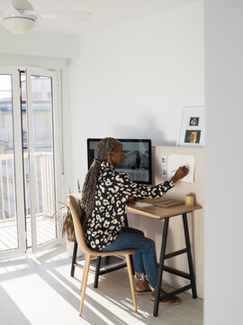 Black female manager writing business in calendar