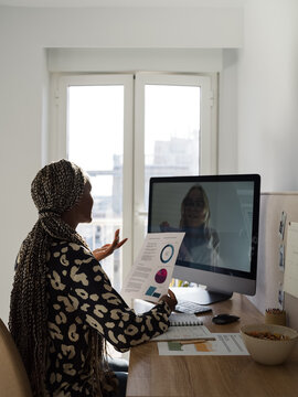 Female economist consulting client via computer