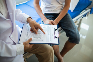 doctor is having consultation discussing prostate cancer and venereal cancer detected in young man....