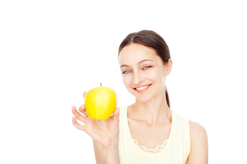 Young happy woman holding yellow apple isolated over white background