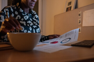 Crop analyst checking diagrams while eating snacks