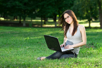 student with notebook in the park