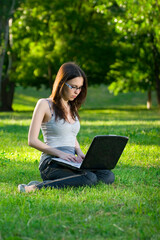 student with notebook in the park