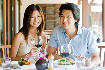 A young Asian couple having dinner at a restaurant