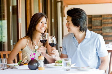 A young Asian couple having dinner at a restaurant