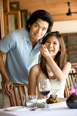 A young Asian couple having dinner at a restaurant