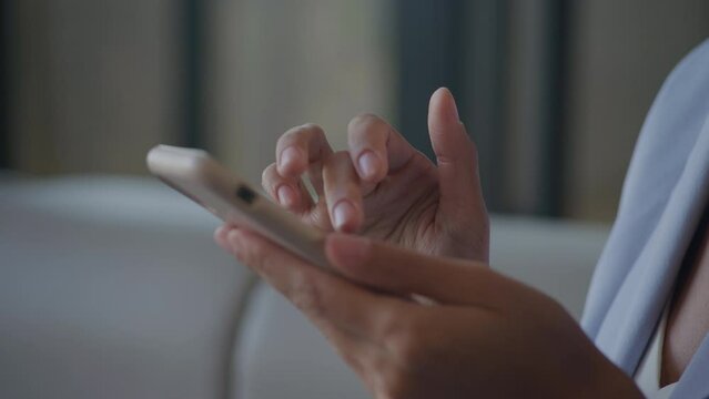 Businesswoman hands browsing on smartphone extreme close up