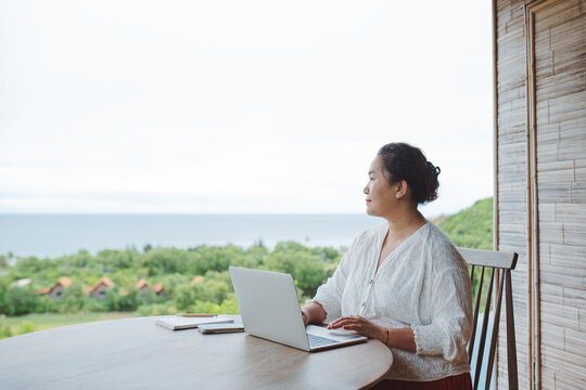 Asian Plus size smiling woman working on laptop freelance 