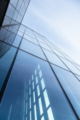 Fototapeta na wymiar Glass office building exterior against the sky