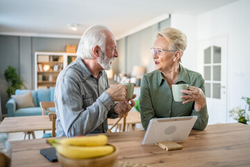 senior couple man woman husband wife have cup of coffee in the morning