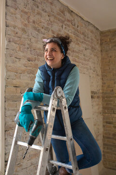 Portrait of a smiling happy woman renovating
