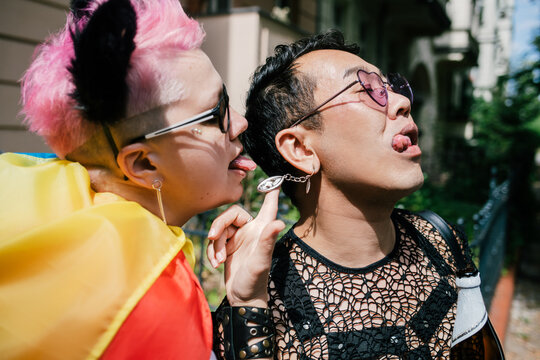 Kinky friends goofing around posing for a photo at pride