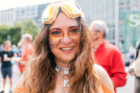Cheerful colourfully dressed up woman at Pride looking at camera