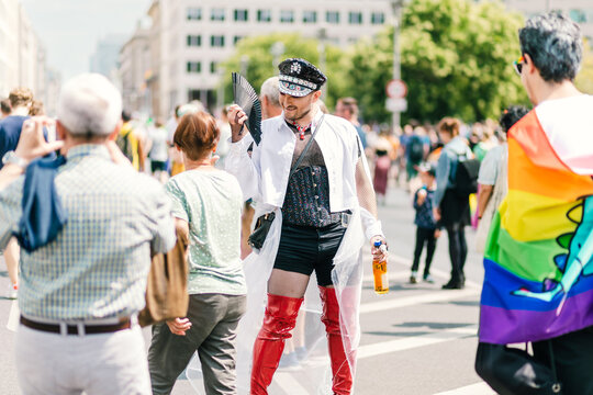 Voguing glam officer in Red heels marching at pride
