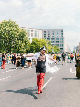 Voguing glam officer in Red heels marching at pride