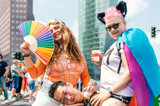 Colourfully dressed friends at a pride parade on Potsdamer Platz 