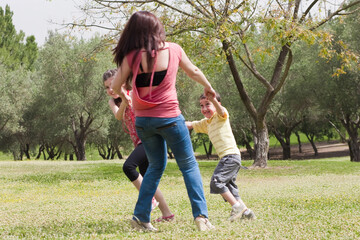 Back shot of a family  playingin the park,outdoor