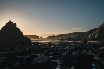 A rocky Pembrokeshire beach at dusk.