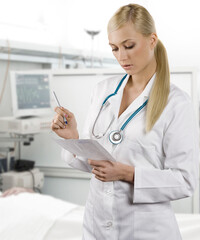 blond medical doctor woman with stethoscope Isolated over white background writing