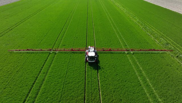 See farming in action from a whole new perspective with our stunning drone footage of a tractor spraying a green crop field.
