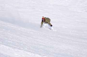 Naklejka na ściany i meble a snowboarder carving on the slope