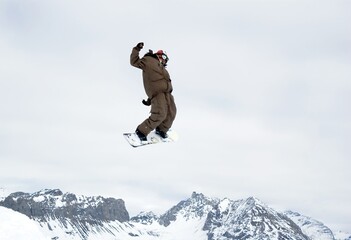 Naklejka na ściany i meble a snowboarder jumping high in the air