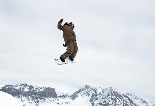 a snowboarder jumping high in the air