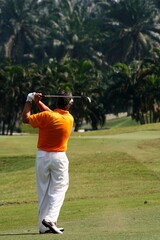 A golfer playing golf in the field.