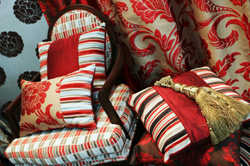 Luxurious red chair with satin pillows - home interiors