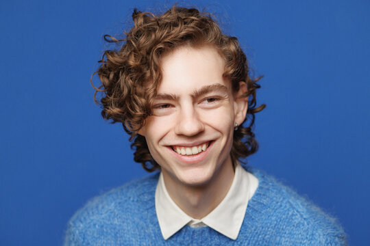 Toothy grin. Headshot. Androgyne face. Blue Background
