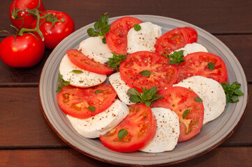 Tomato and mozzarella Caprese salad with sauce 