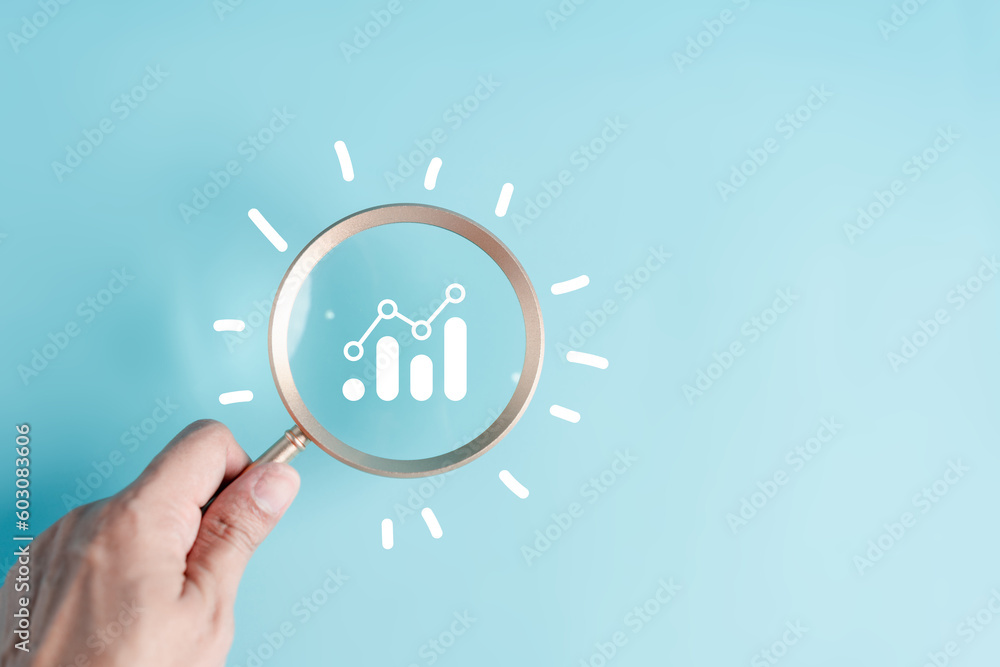 Aufkleber hand holding magnifier to analysis portfolio management with lightbulb icon for planning development