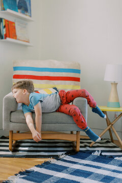 Boy Slumped on Chair Looking Bored