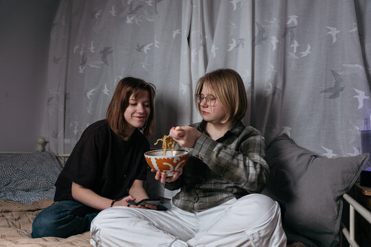 Teenager gitls eating noodles