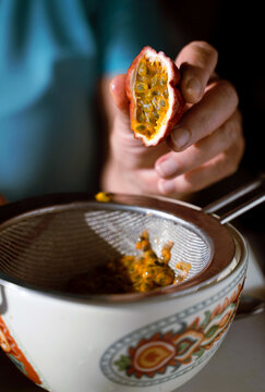 Female Hand Juicing Passion Fruit 