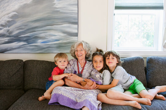 Granny with beloved grandchildren on sofa