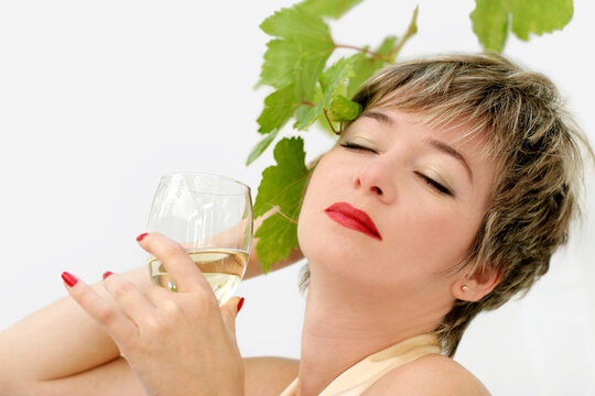 Woman in a formal dress enjoying a glass of wine