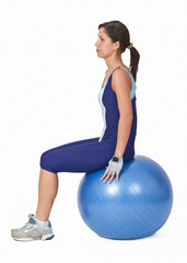 Young active woman sitting on a blue fitness ball