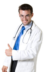 Fototapeta premium Young attractive man doctor wearing white lab coat holding thumb up wearing a stethoscope around shoulders smiling standing on white background
