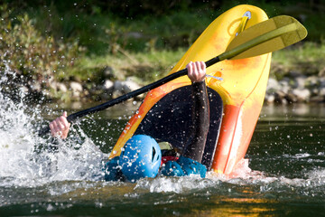 expert white water kayak paddler performing tricks
