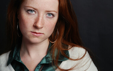 Portrait of the girl with freckles and red hair