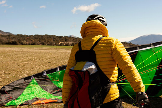man walking and holding a parachute 