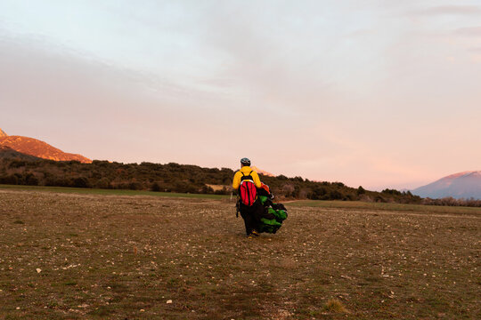 man holding parachute during sunset 