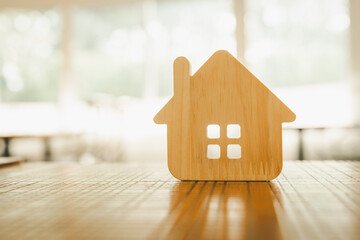 Wooden house model on wood background, a symbol for construction , ecology, loan, mortgage,...