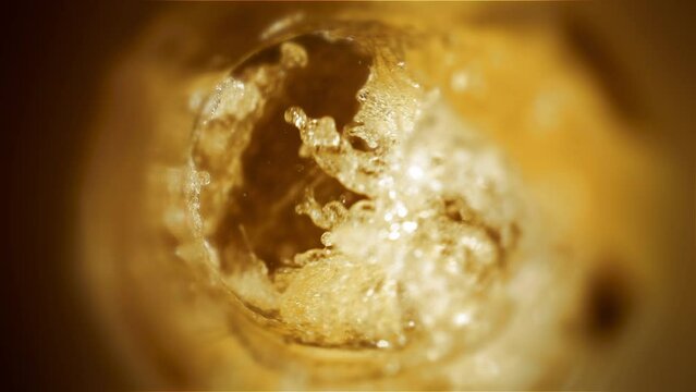 Craft IPA microbrewery:  a Liquid Symphony in high-speed 4K. Refreshing craft IPA beer poured into a glass in stunning slow-motion. Witness the artistry of brewery craftsmanship—Froth cold beer. 