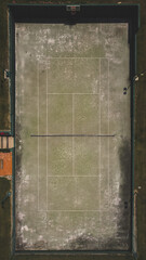 Aerial top view of abandoned tennis court