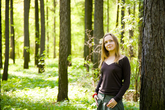 Young Lady Walking In Spring Forest