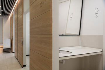 Modern clinic bathroom space with gender signs