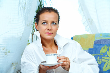 High key portrait of nice gorgeous woman drinking coffee