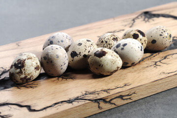 Quail eggs, fresh quail eggs and feather on table background, raw eggs egg shell